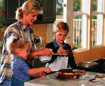 Above Rubies mom and kids making cake